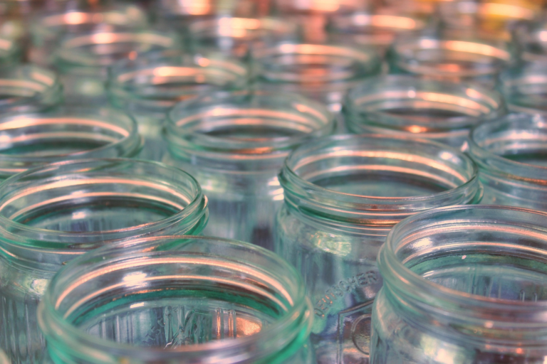 Rows of empty canning jars without lids or rings.