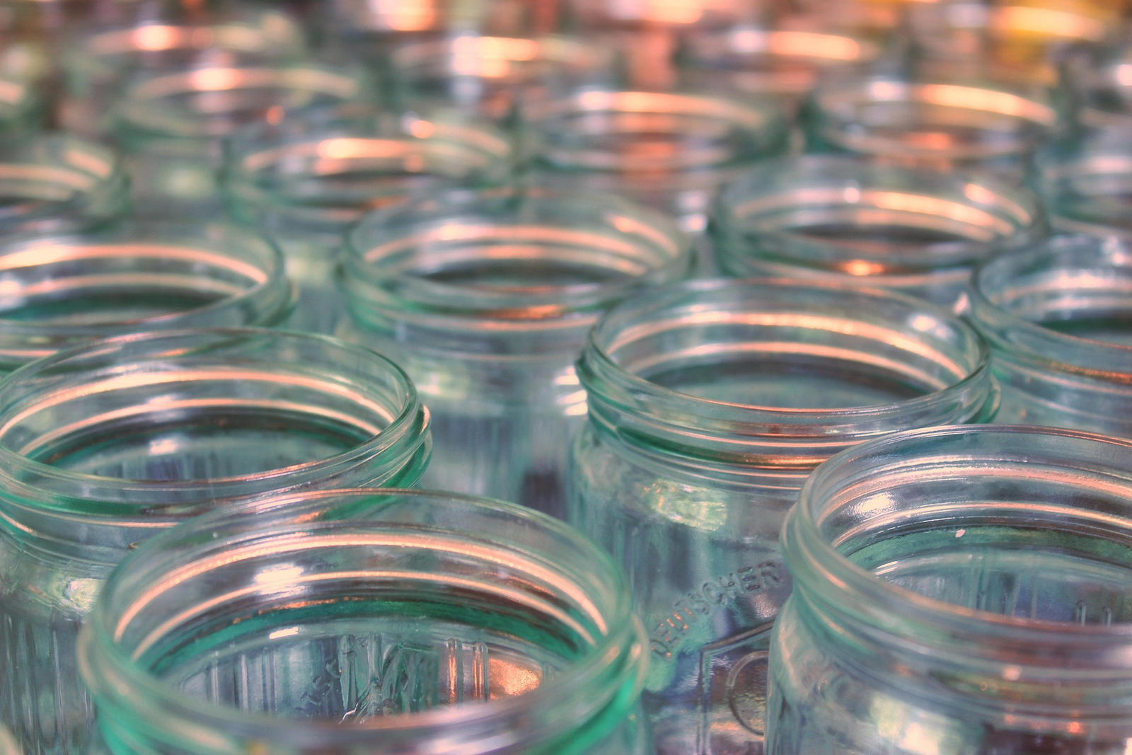 Rows of empty canning jars without lids or rings.